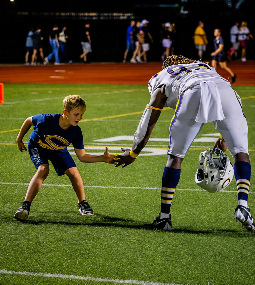 Benny Patterson III high fiving a young fan