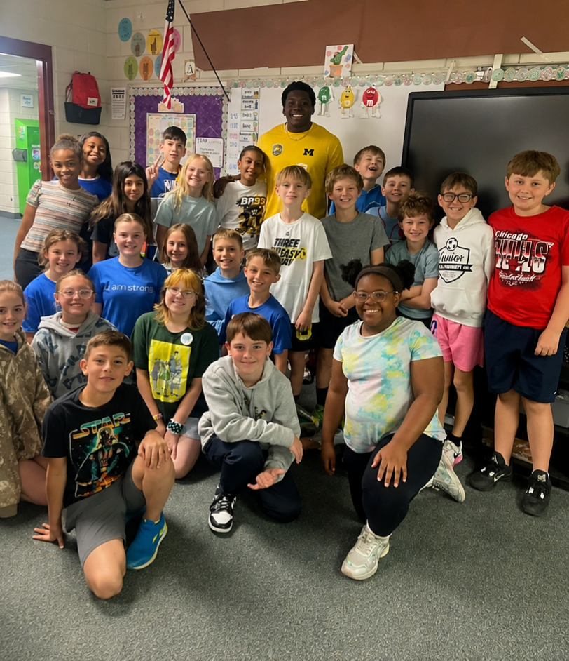 Benny Patterson III posing with a classroom of students